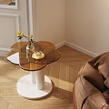 Modern Round Top Side Table With White Base Near Bean Bag Chair And Floor Lamp