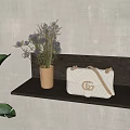 White fashion bag on dark wooden shelf with golden vase purple flowers and green plants