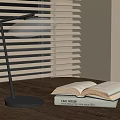 Modern Minimalist Table Lamp on Wooden Table with Open Book and Window Blinds