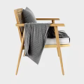 Modern Wooden Armchair With Grey Cushion And Blanket On Armrest