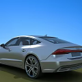 Silver Modern Sedan With Sleek Exterior Design On Green Grass Under Blue Sky