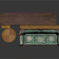 Vintage Green Floral Sofa With Small Round Table Against Dark Paneled Wall and Picture Frames