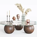 Glass Top Coffee Table With Walnut Wood Sphere Bases Candles Books Sculpture And Pampas Grass