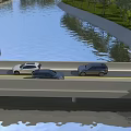 Bridge With Cars Driving Over River Surrounded By Green Trees And Grassy Banks