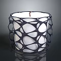 Black Intricate Cutout Candle Holder With White Candle And Modern Design