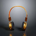 Gold and Black Over Ear Computer Headphones with Orange Headband and Reflection on Gray Background