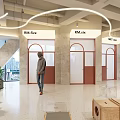 Modern Open Leisure Area Interior With Curved Lights Wooden Crates And Green Plants