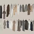Various Styles Different Colors Clothes Hanging On Hangers Against Light Colored Wall