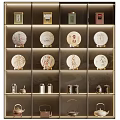 Elegant Tea Set Display Featuring Tea Cakes and Canisters in Glass Cabinet with Golden Borders
