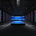 Spacious Indoor Venue With Rows of Chairs Large LED Screen and Central Platform