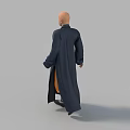 Bald Man in Full Length Dark Blue Robe Standing Against Gray Background
