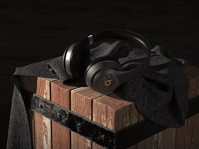 Black Over Ear Headphones Placed On Wooden Crate With Dark Cloth 3d model