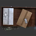 Wooden Wardrobe With Mesh Doors Drawers Below Plaid Shirt Hanging And Cardboard Boxes On Top