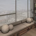 Cozy Window Seat With White Blinds Round Cushions Wooden Drawers And Green Plant