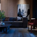 Modern Dark Grey Sofa And Round Coffee Table Set With Green Plant And Wall Art
