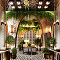 Elegant Nature Themed Hotel Lobby With Lush Green Plants Arched Decor And Warm Ambient Lighting