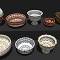 Colorful Ceramic Bowls and Vases with Intricate Decorative Patterns on Black Shelf
