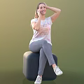 Woman Sitting On Black Cube Talking On Phone In White T-shirt Gray Pants White Sneakers