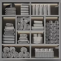 Soft Gray Cotton Towels Rolled And Stacked On Organized Wooden Shelf
