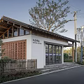 Traditional Chinese Post Station With Wooden Roof White Walls Grille Windows And Roadside Trees