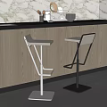 Modern Bar Stools With White Seats And Metal Frames At Kitchen Counter With Wooden Cabinets
