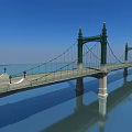 Suspension Bridge With Green Towers Over Calm Water Street Lamps Blue Sky And Reflection