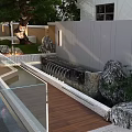 Modern Garden Landscape With Water Pond Lighting Trees And Rock Features