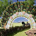 Peacock Feather Decorated Arched Entrance Gate With Grass Trees Stone Pathway And People Walking