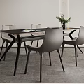Modern Dining Table Set With Gray Chairs Wooden Tabletop Black Legs Green Plant And Magazine