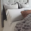 Bedroom Bedding Set With Gray Upholstered Headboard Pillows Brown Cushion Patterned Comforter And Knit Blanket