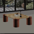 Marble Coffee Table With Copper Cylindrical Legs In Sunlit Room With Window Blinds And Books