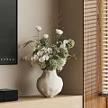 White Ceramic Vase With Fresh Green And White Flowers On Wooden Shelf