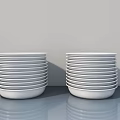 Decorative Ornament Set with Stacked White Plates on Gray Countertop Light Gray Background and Reflections