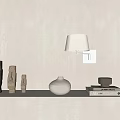 Minimalist Wall Sconce with White Shade Wooden Figurines White Vase and Books on Shelf