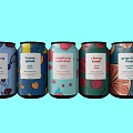 Colorful Sparkling Drink Cans With Different Flavors And Vibrant Patterns On Light Blue Background