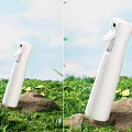 White Cosmetic Perfume Spray Bottle On Green Grass With Yellow Flowers And Blue Sky