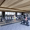 Modern Gym Interior With Various Fitness Equipment And People Working Out