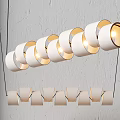 Modern Interior Pendant Lights With White Cylindrical Shades Arranged In Double Rows On Grey Wall