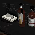 Wine Bottles And Glass On Black Marble Table With BOWMORE And Various Labels