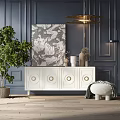 White TV Stand With Circular Accents Against Dark Blue Wall Decorative Painting And Green Plant