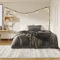Cozy Modern Bedroom Interior With Gray Bedding String Lights Area Rug And Desk Chair