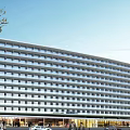 Modern Waterfront Hotel Building With Landscaped Gardens And Architectural Design