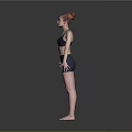 Woman Standing in Dark Sports Bra and Shorts with Arms Outstretched on Gray Background