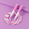Colorful Pink And White Jump Rope With Pink Handles On Purple Surface