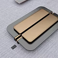 Golden Metal Cabinet Handle Design On Black Panel With Gray Fabric Surface