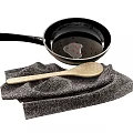 Essential Kitchen Utensils Frying Pan Wooden Spoon and Gray Cloth with Oil and Red Spices