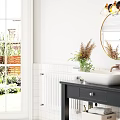 Modern Bathroom With Round Gold Framed Mirror Black Countertop Vanity White Sinks And Green Plants