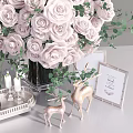 Pink Roses And Eucalyptus Leaves In Black Vase With Deer Figurines Picture Frames And Candles