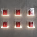 Stylish Wall Decor Featuring Transparent Cube Cases with Red Items and Lighting on Gray Wall