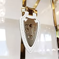 Elegant Display Cabinet Featuring White Leather Decor With Gold Metal Buckle And Letter Pattern